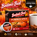 Boston's Best Coffee Roasters Pumpkin Spice single-serve coffee pods box, shown with a single pod, a white mug of coffee, pumpkins, cinnamon sticks, star anise, and autumn leaves on a wooden surface.