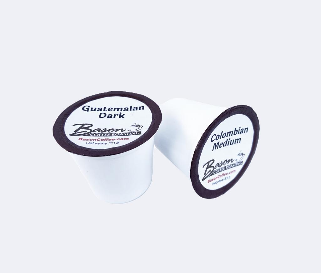 Two coffee pods with 'Besson Coffee' branding on a white background