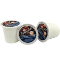 Three Bauer's Best Hazelnut Creme coffee pods on a white background