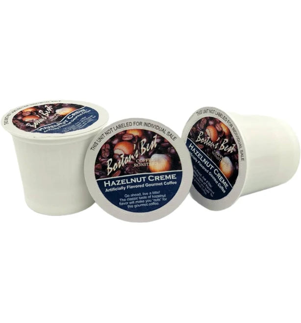 Three Bauer's Best Hazelnut Creme coffee pods on a white background